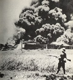 The oil tanks burning at Palembang, Sumatra Island in 1942